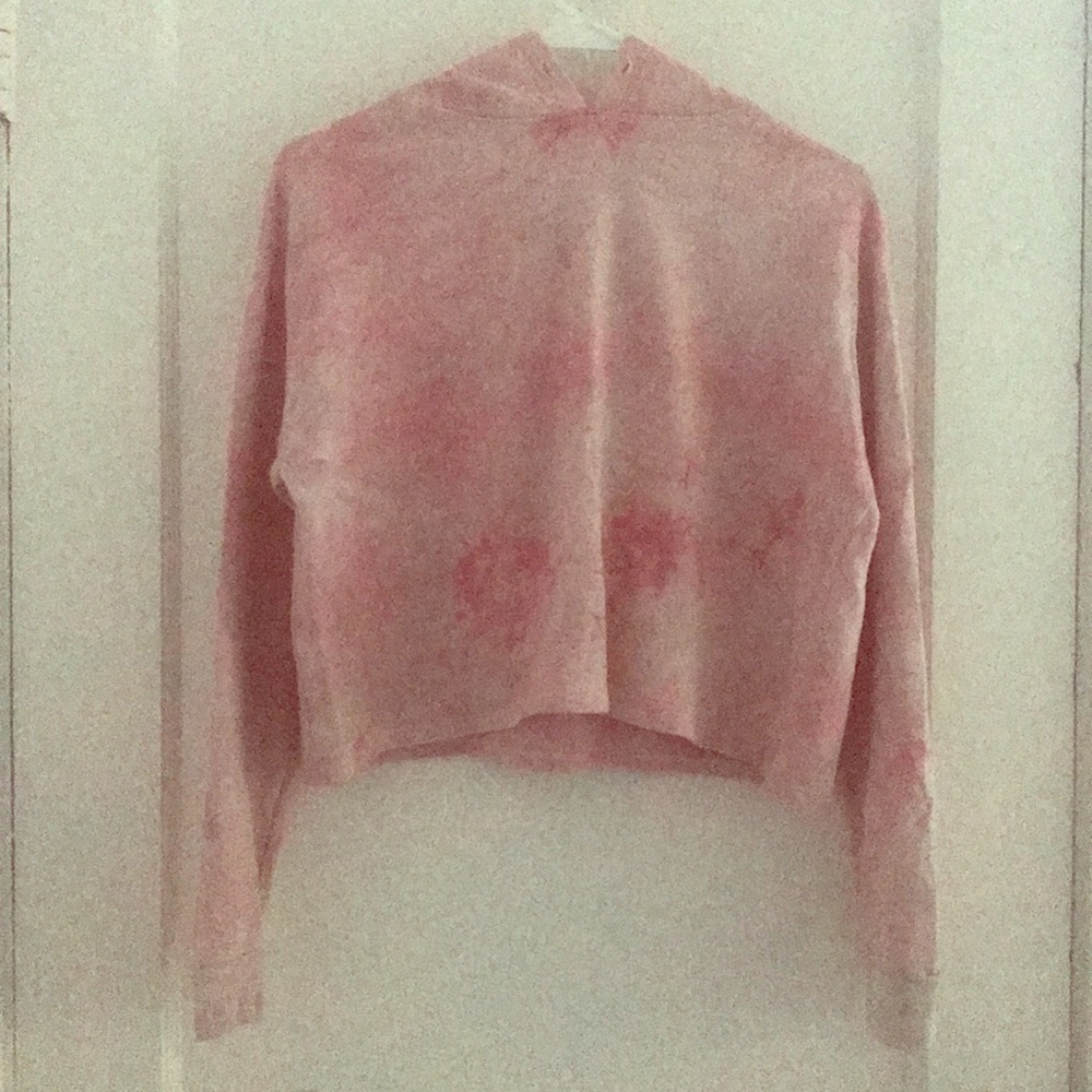 A pink crop top with long sleeves with hoddie